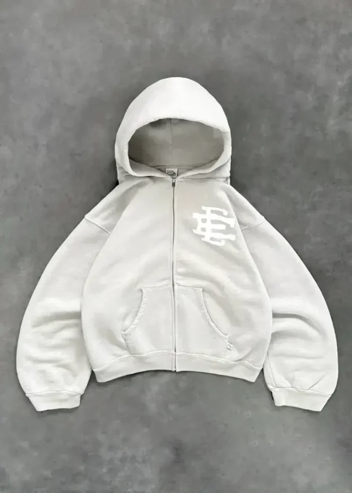 1 / 1 – ERIC-EMANUEL-x-AKIMBO-x-TYRRELL-WINSTON-ZIP-UP-HEATHER-GREY